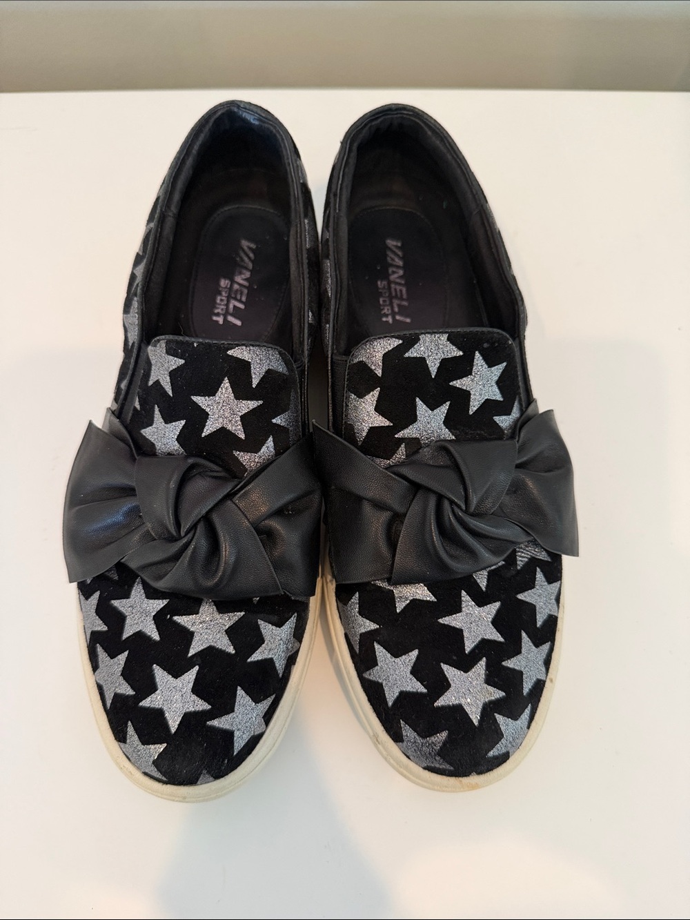 Vaneli Black Slip-On Sneakers with Silver Star Print and Knot Bow
